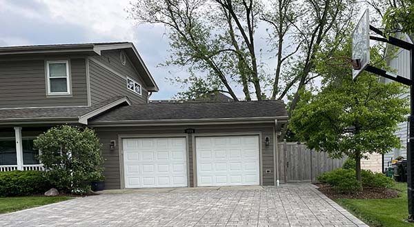 garage with brick pavers